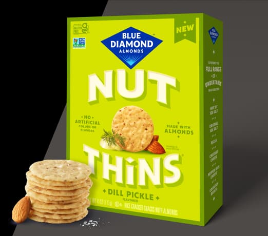 Nut-Thins Dill PIckle packing next to stack of crackers