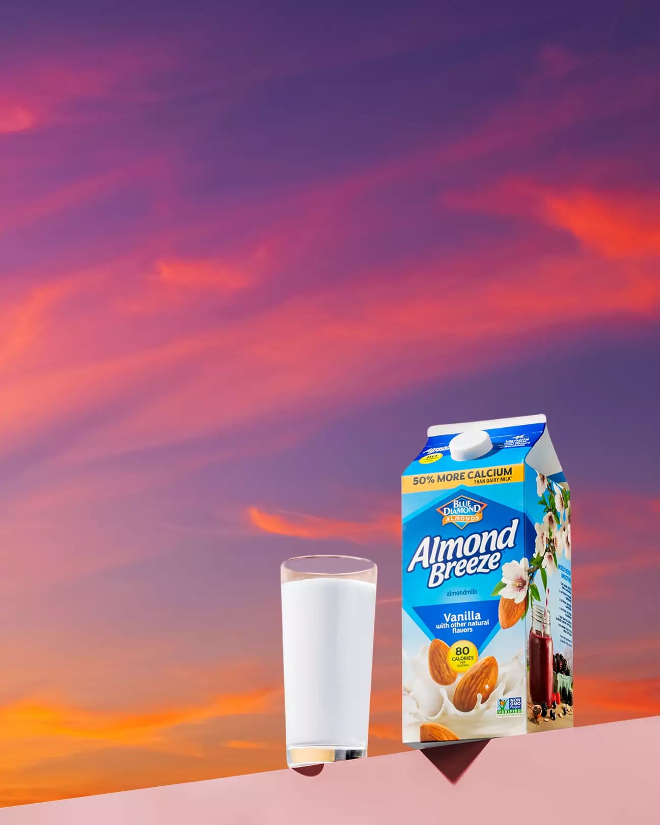 Carton of Almond Breeze almond milnk with sunset background.