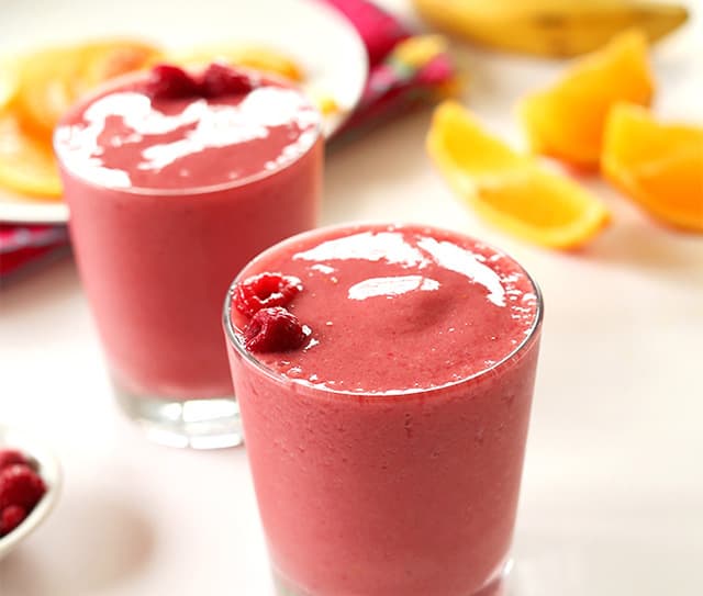 Tabletop with two raspberry pomegranate smoothies